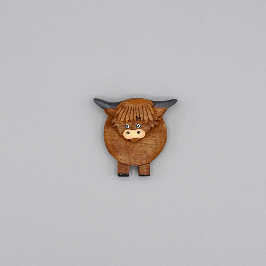 A wooden Highland cow magnet