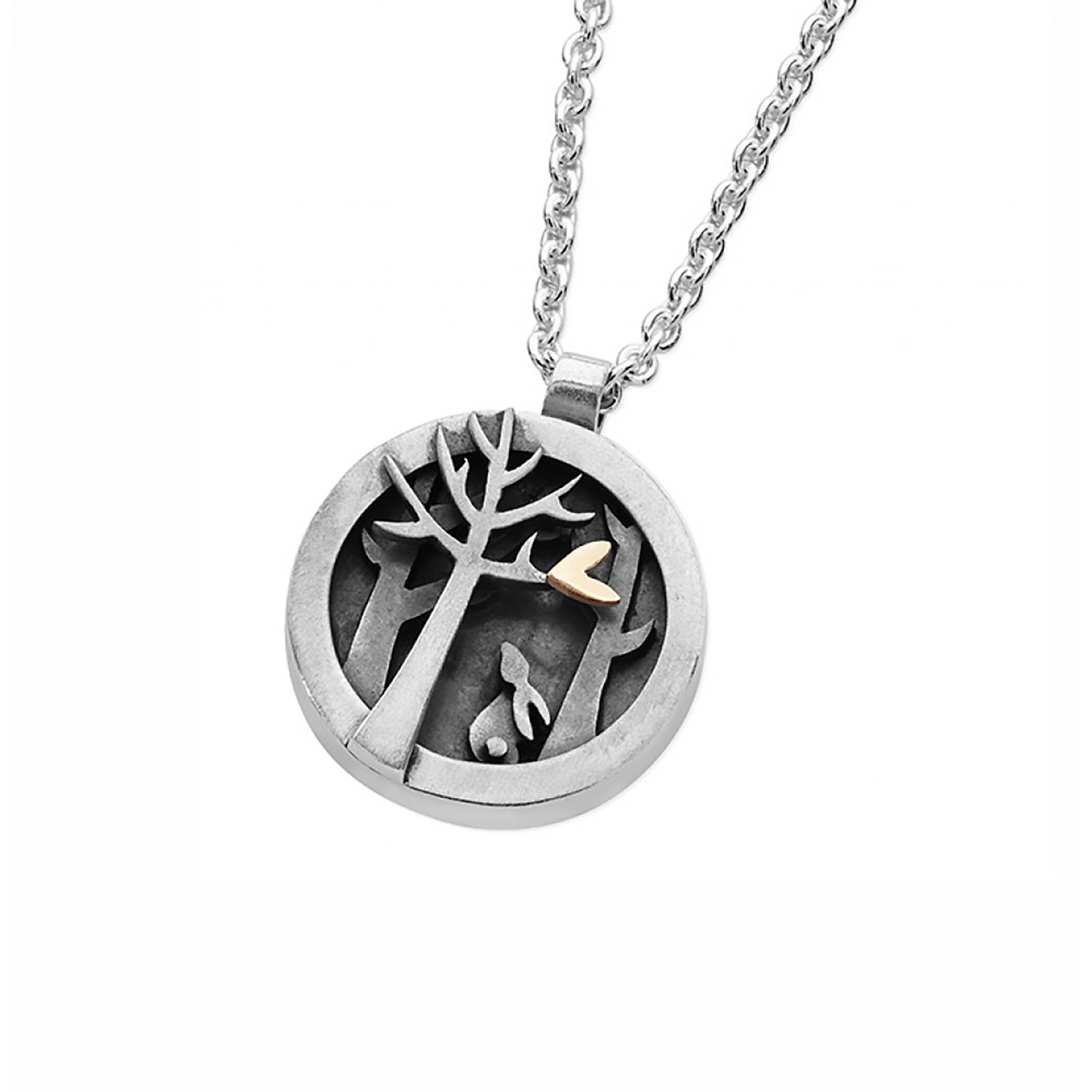 Detailed round silver pendant with layered forest details, a bunny and a little gold heart, on a silver chain