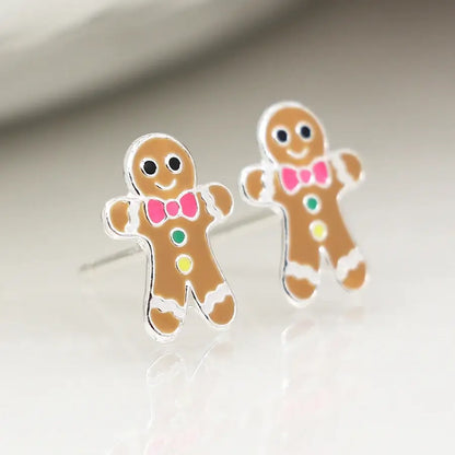Pair of silver stud earrings shaped like gingerbread men with enamelled details