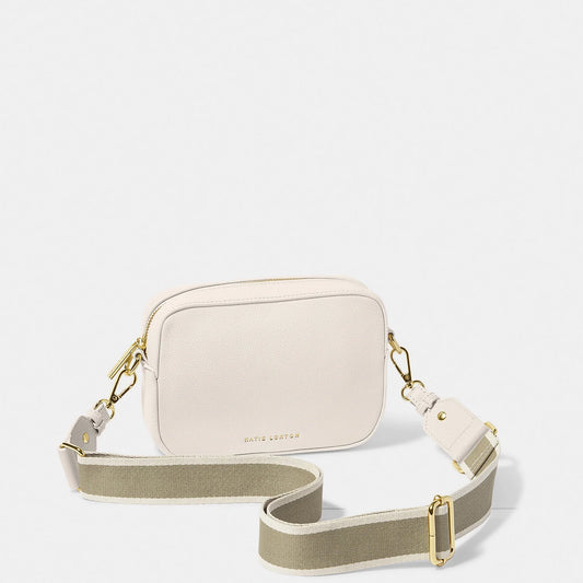 An off-white crossbody bag in a simple box shape with adjustable canvas strap and gold hardware