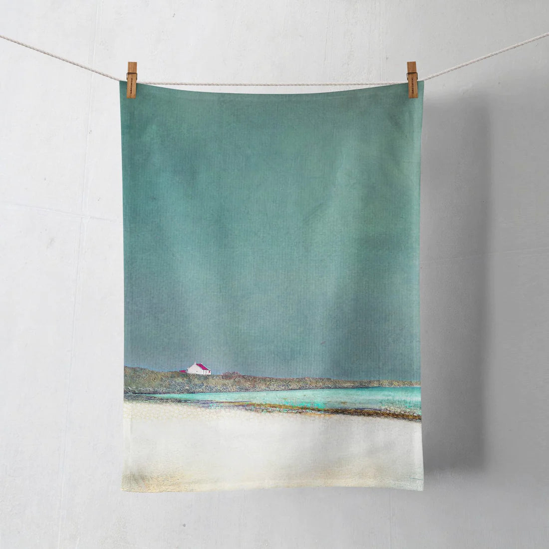 Tea towel with a print of a seascape from the Isle of Barra in teal blues