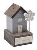 Small wooden cottage ornament in grey and wood with a plaque reading 'Home Sweet Home'