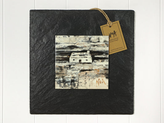 Wall art of a small white cottage in a field done natural and stoney tones done in an abstract style onto a square ceramic tile mounted on square slate