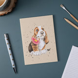 A6 size paper notebook in taupe with sitting basset hound puppy watercolour art cover